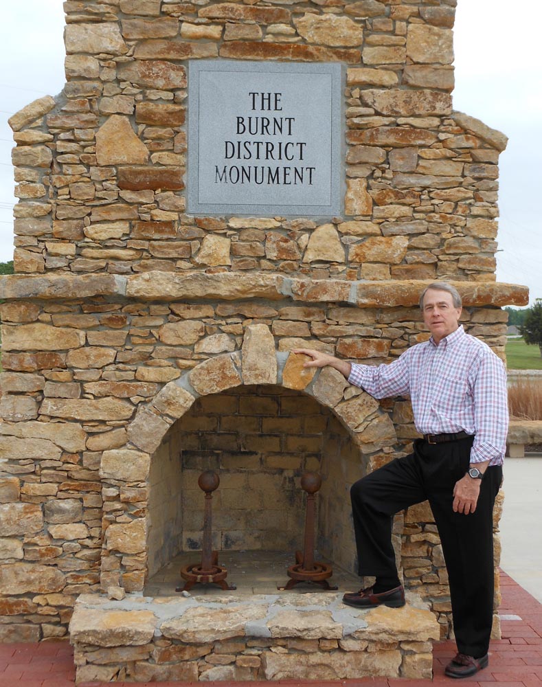 Image of Tom Rafiner with a Burned District monument in Kansas City