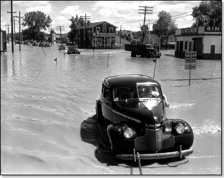 RG107_Series2_292A_009 – A car is towed out of floodwaters in Cedar City, MO, 1951.