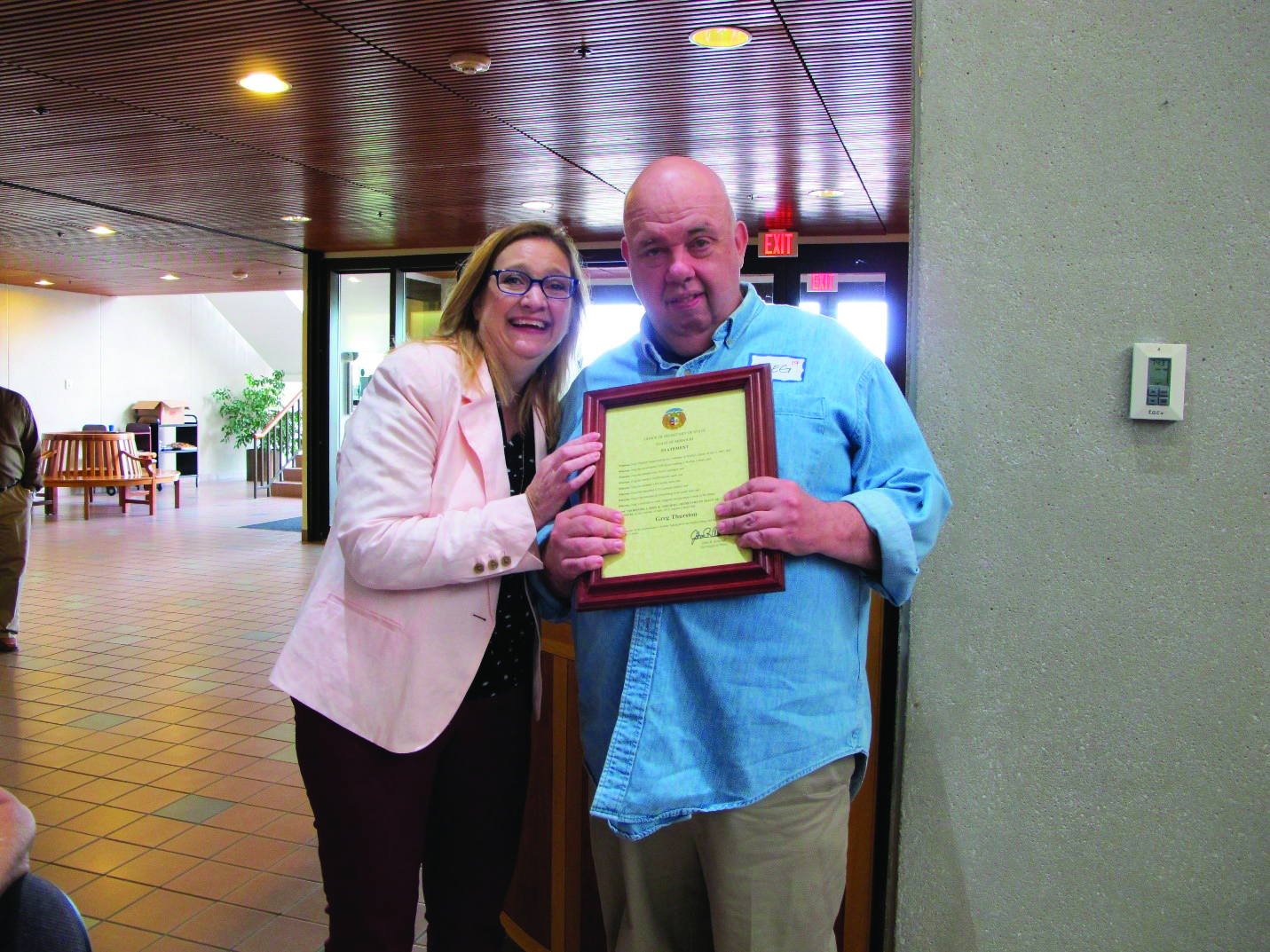 Greg Thurston and Robin Westphal holding a proclomation to Greg's service.