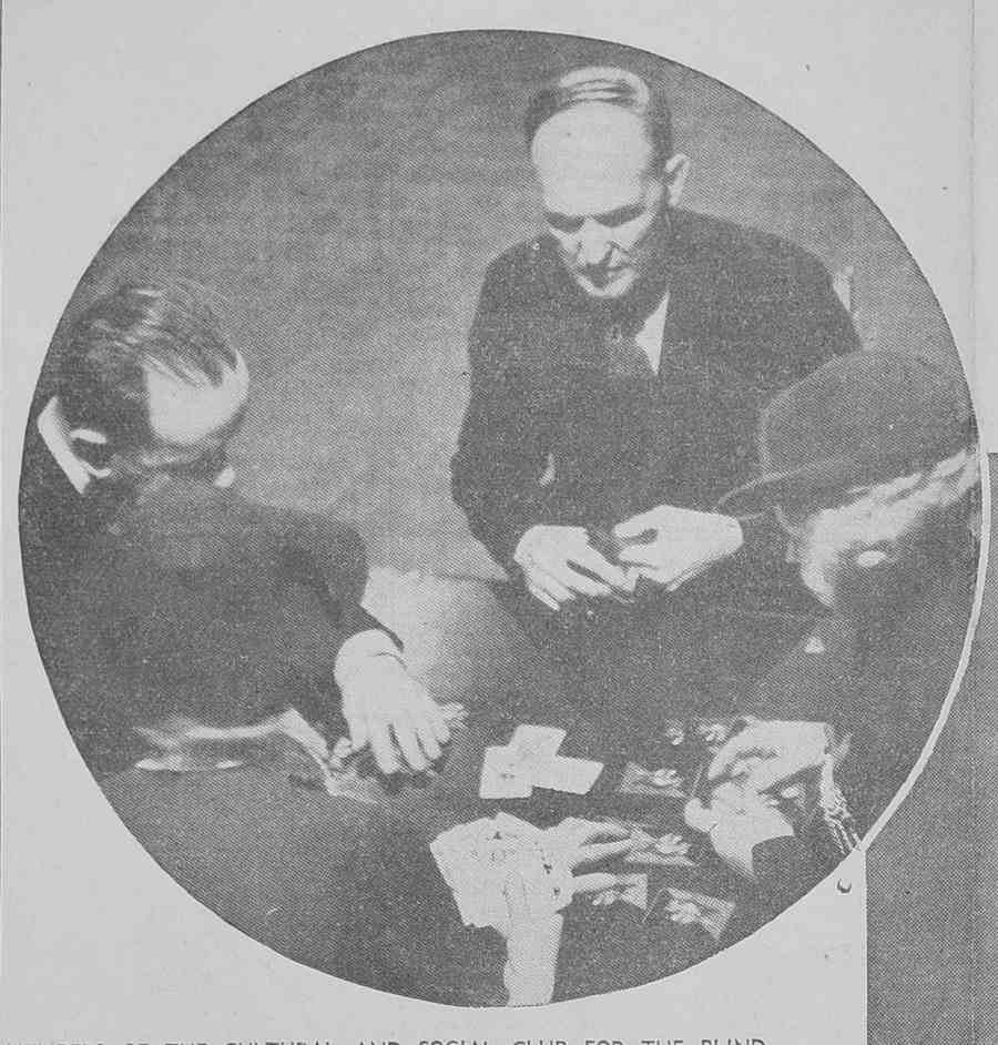 An old photograph of four men playing with braille cards around a table.