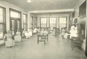 Rocking chair therapy on a female ward, c. 1913.